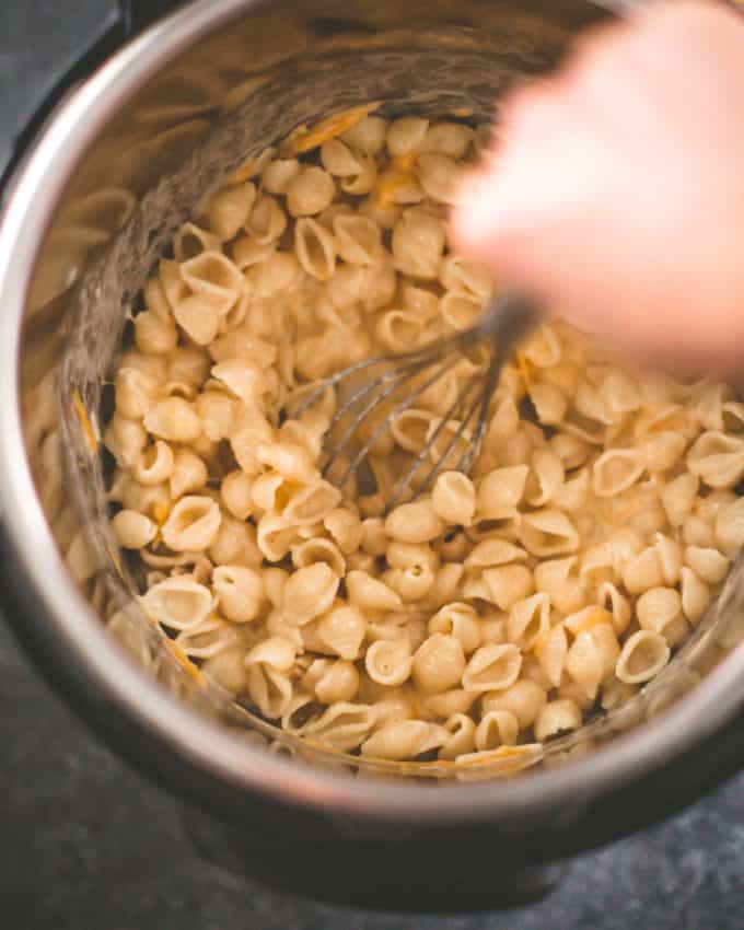 stirring mac and cheese in the Instant Pot
