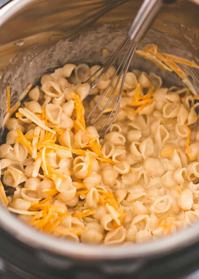 stirring cheese into pasta