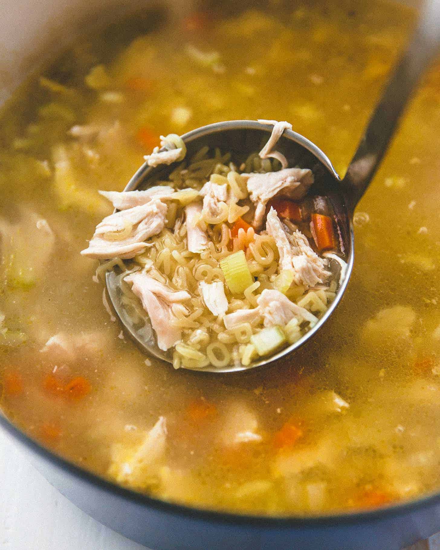 overhead image of chicken noodle soup with miso in a ladle