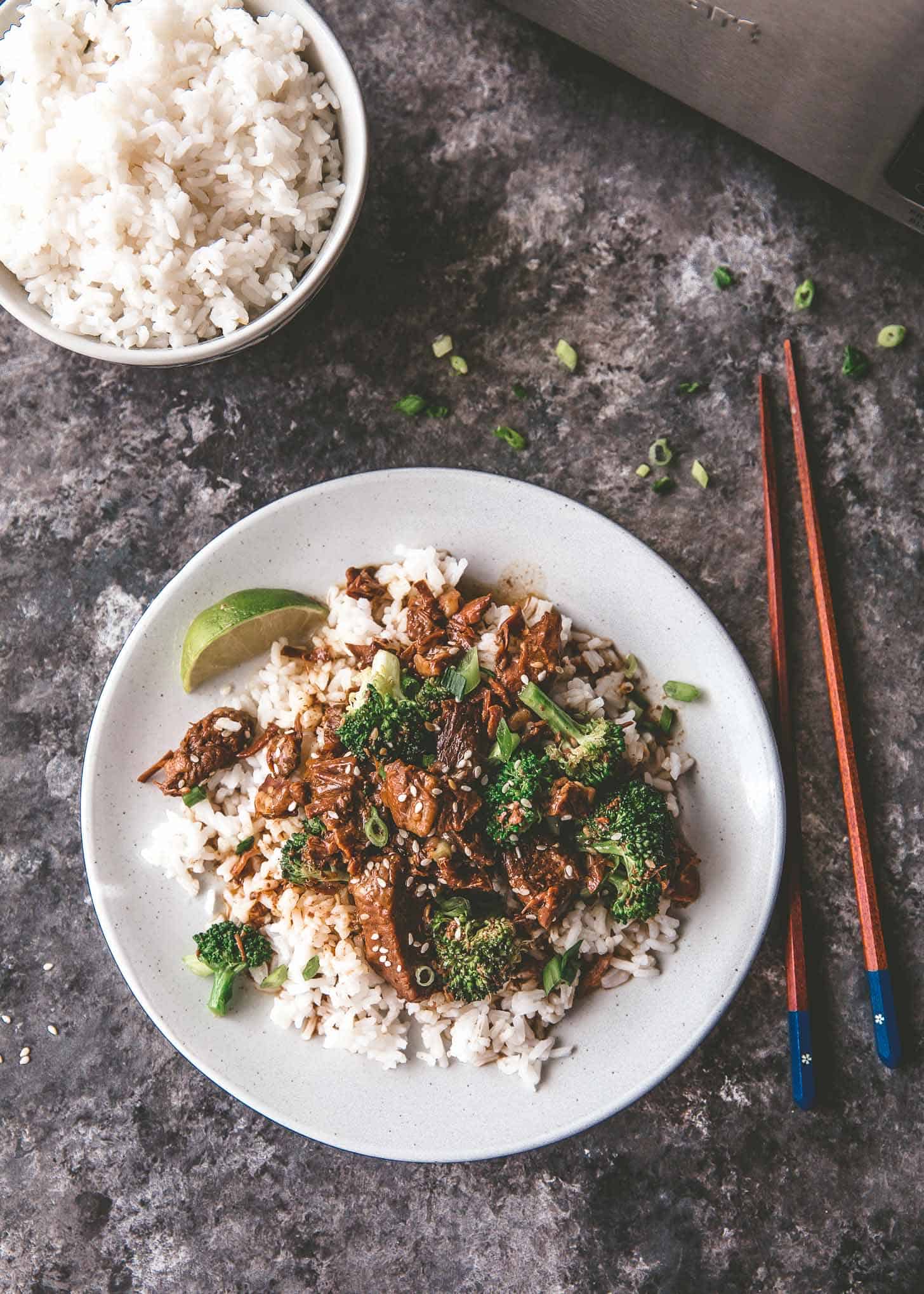 overhead image of beef and broccoli over rice on a white plate