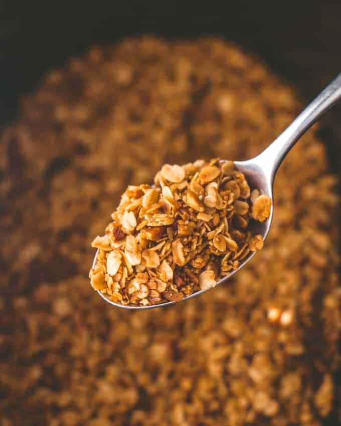 a spoonful of granola over a slow cooker