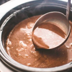 a ladle over slow cooker hot chocolate
