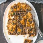 slow cooker breakfast casserole slices on a white oval tray