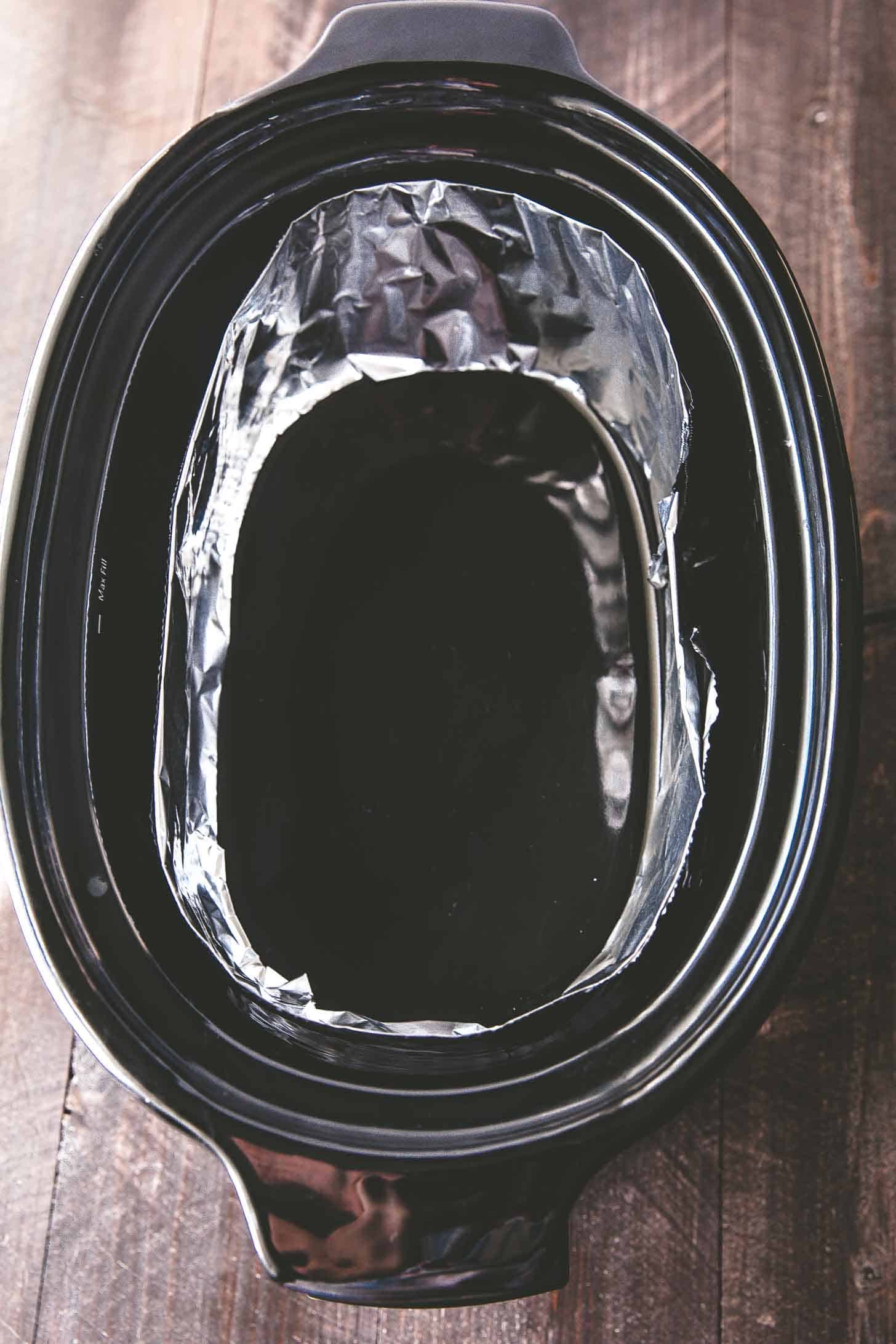 overhead image of a foil collar in the slow cooker