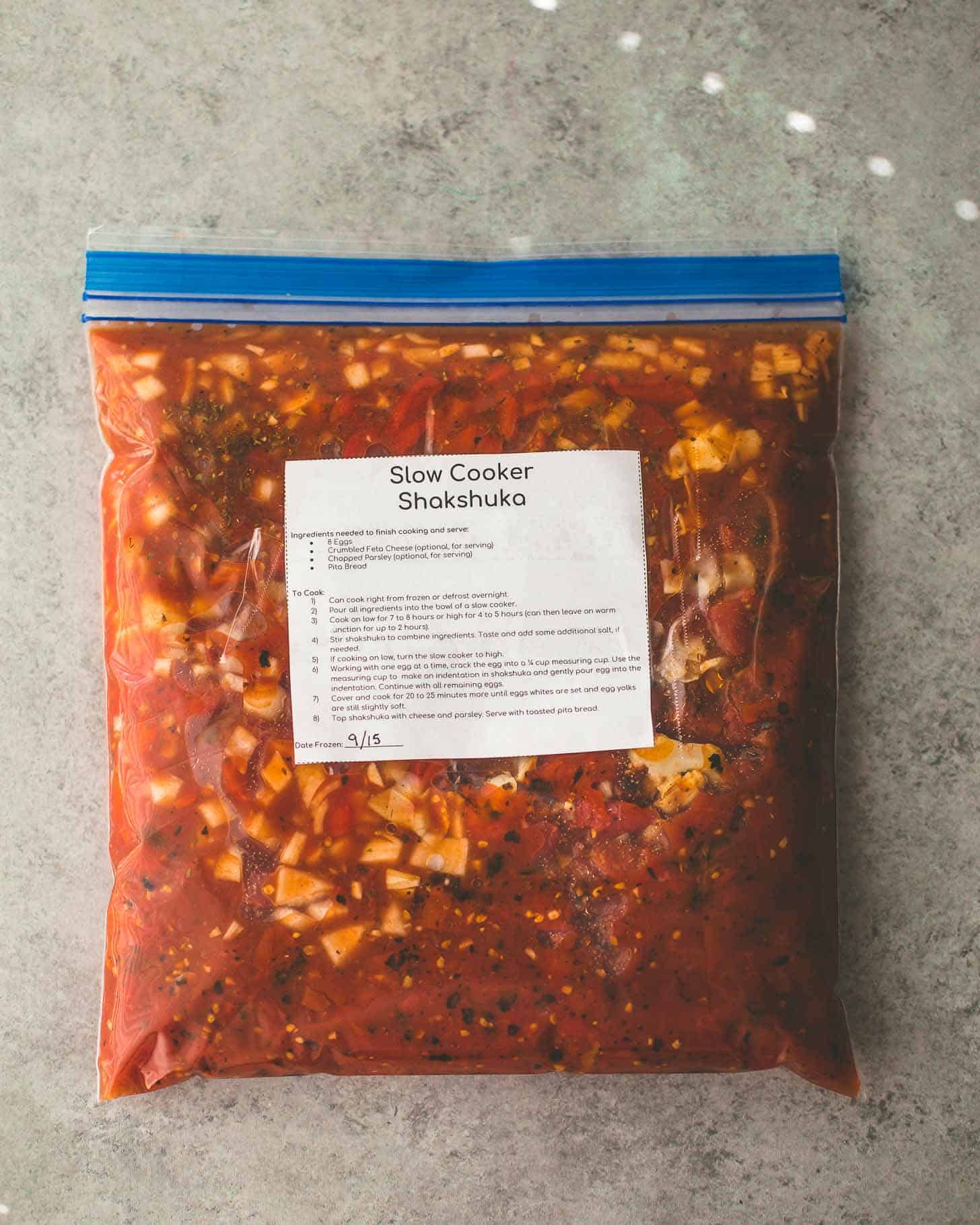overhead image of slow cooker shakshuka in a freezer bag with a label