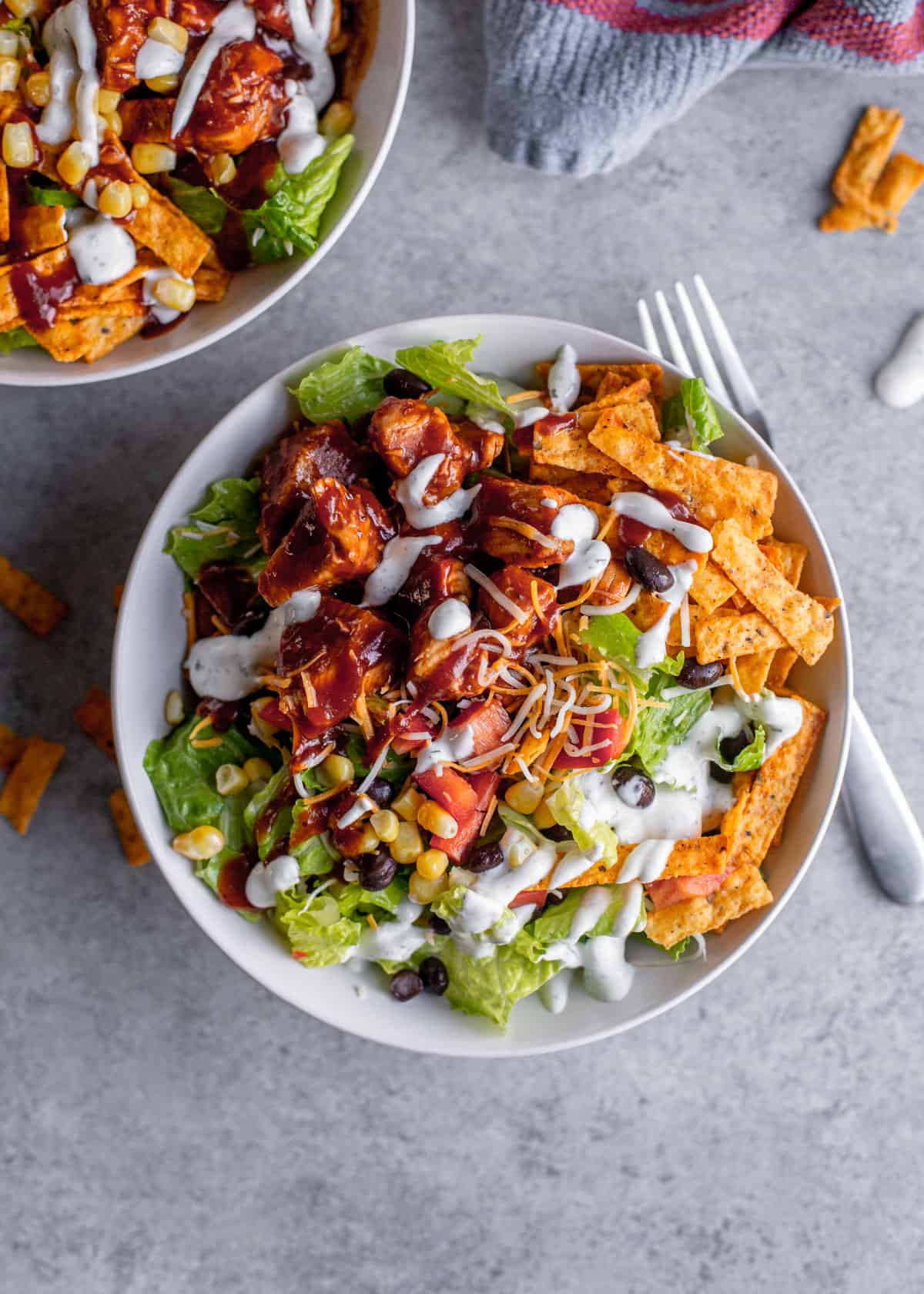 overhead image of bbq chicken salad with tortilla strips and creamy ranch dressing