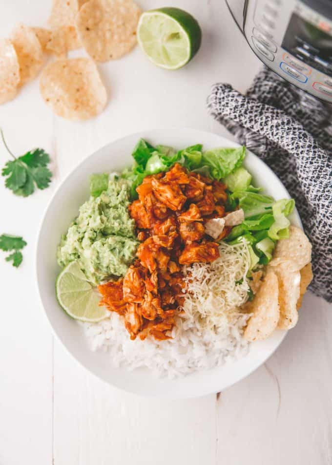 chicken burrito bowls over rice in a white bowl