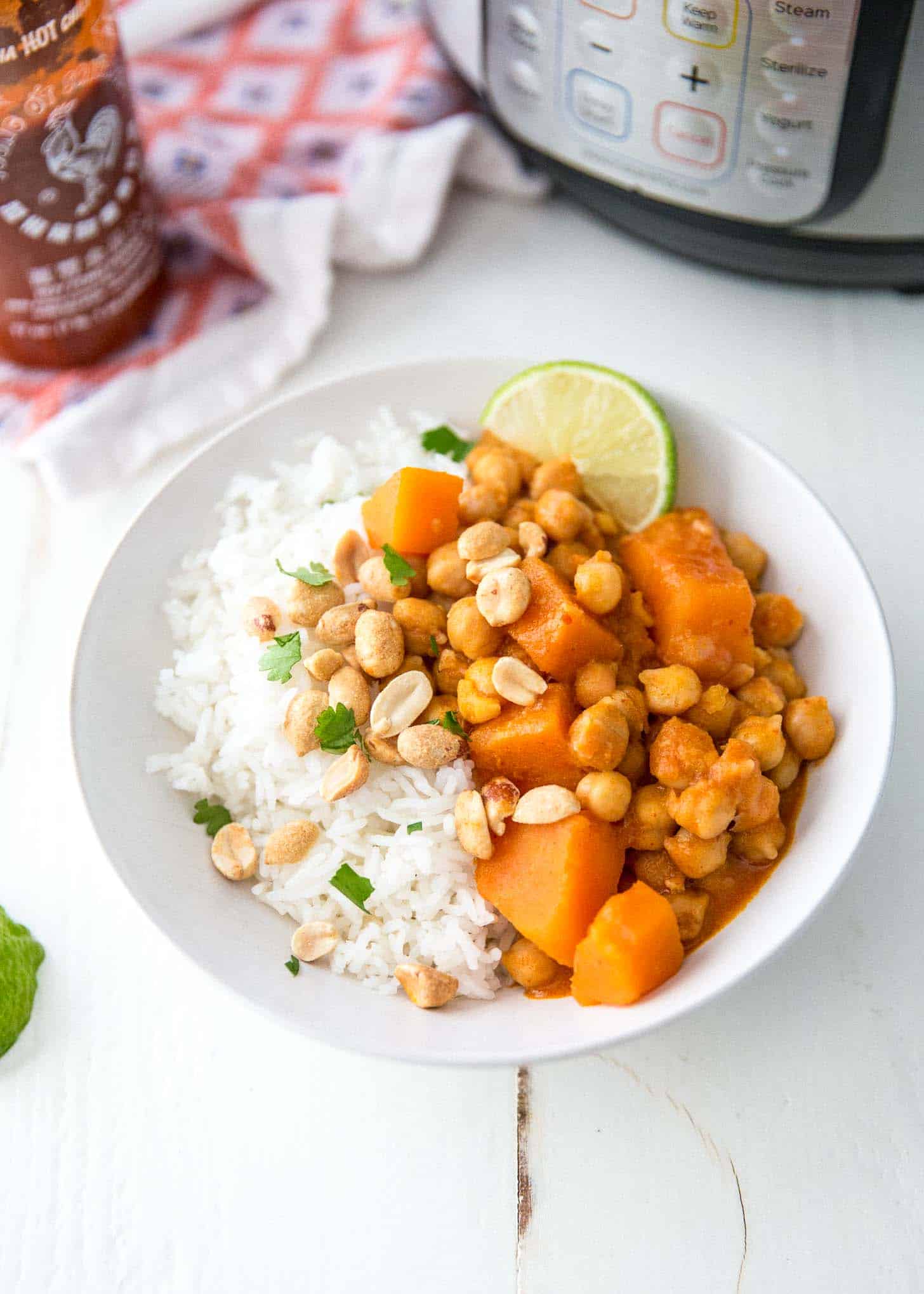 thai panang curry over rice in a white bowl