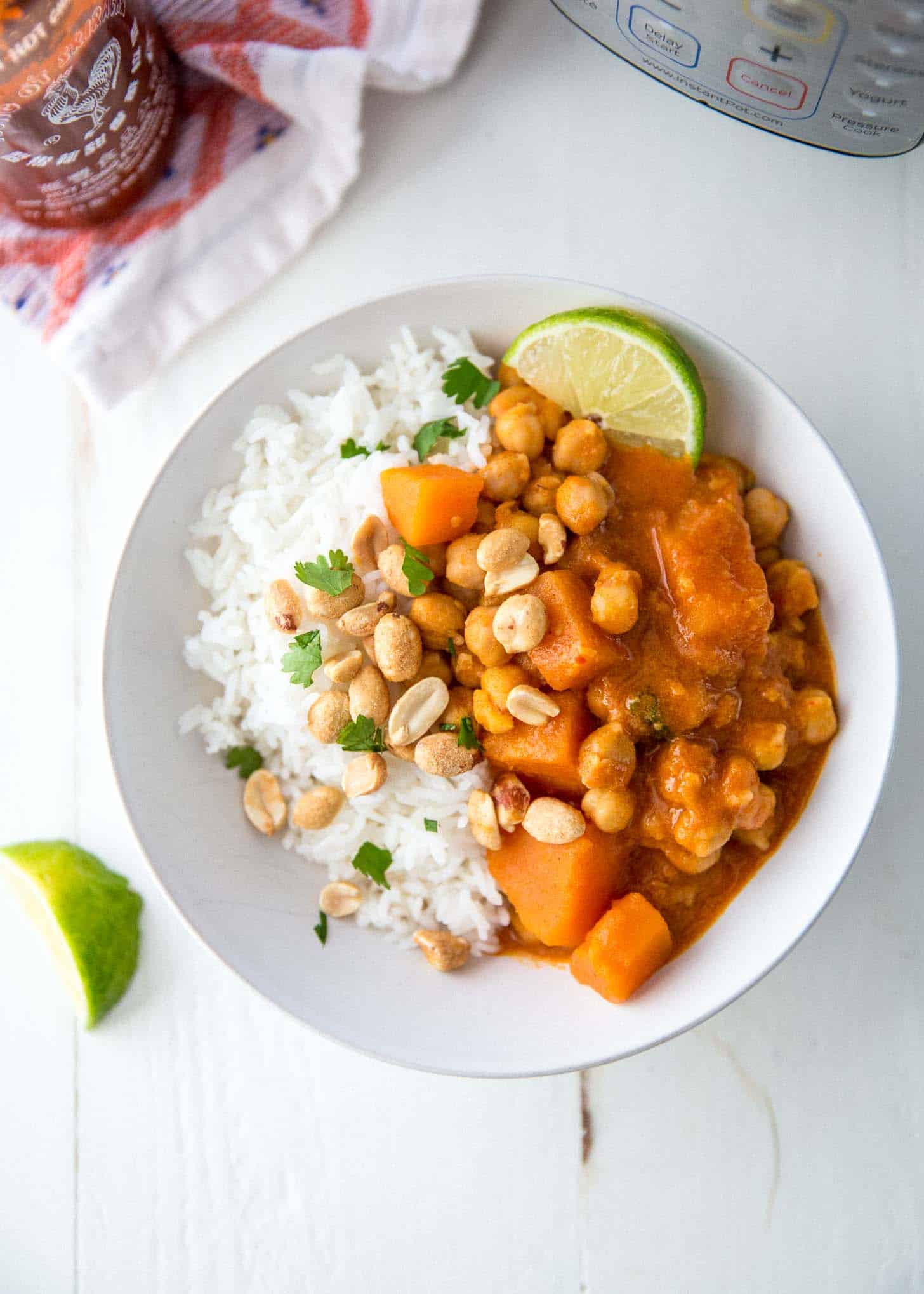 thai panang curry over rice on a white plate