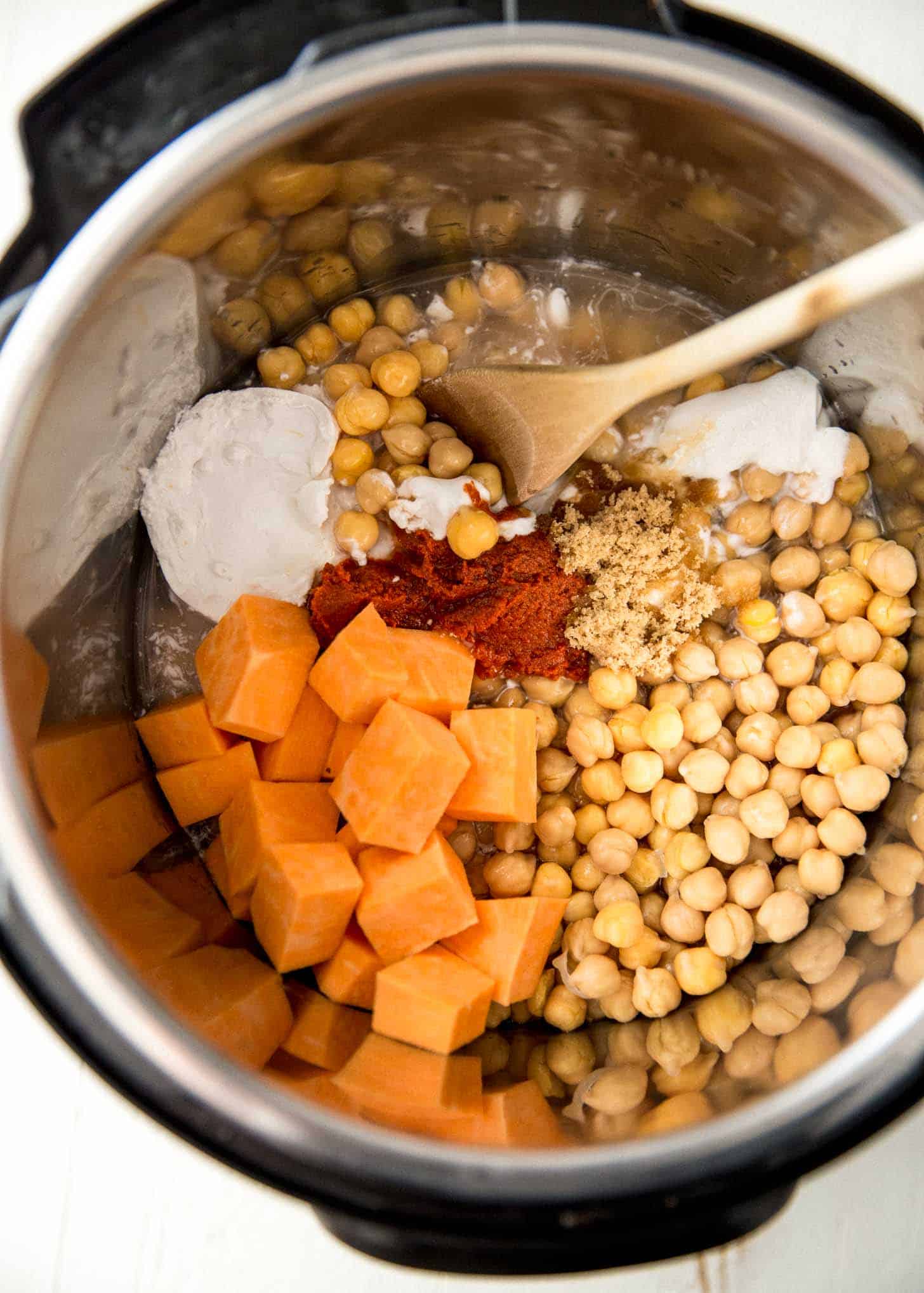 adding panang curry ingredients to an instant pot