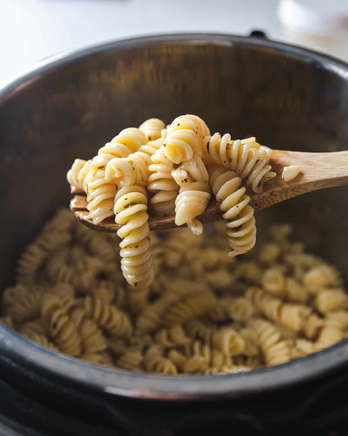 a spoonful of cooked pasta over an open instant pot