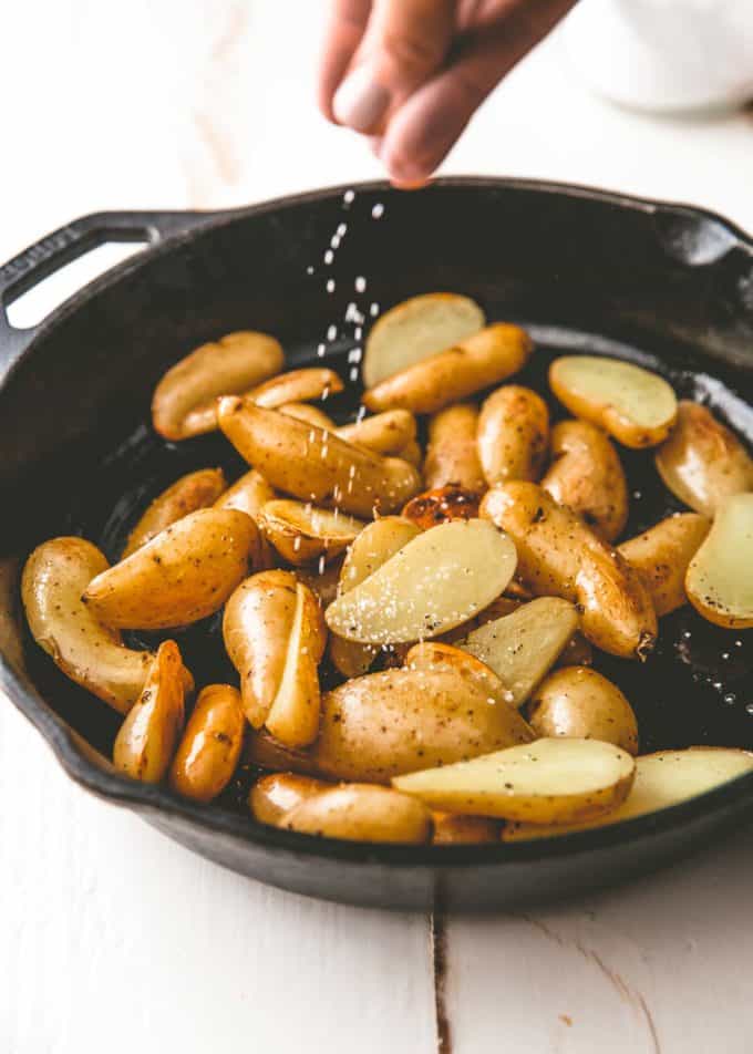browning fingerling potatoes in a cast iron skillet