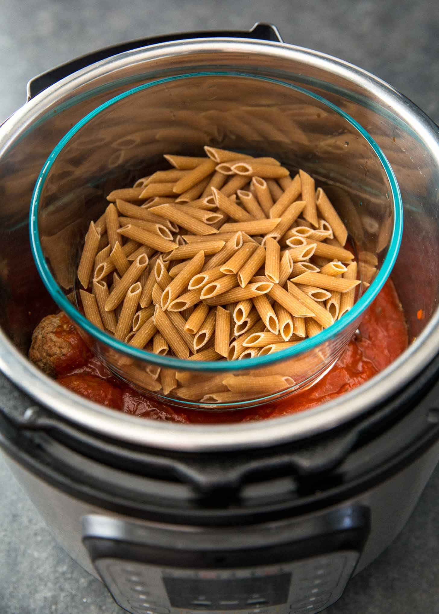 overhead image of pasta sauce and pasta cooking in the Instant pot