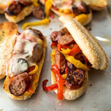 sausage and peppers on a bun and topped with cheese