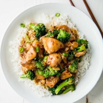 Instant Pot General Tso's Chicken over rice on a white plate