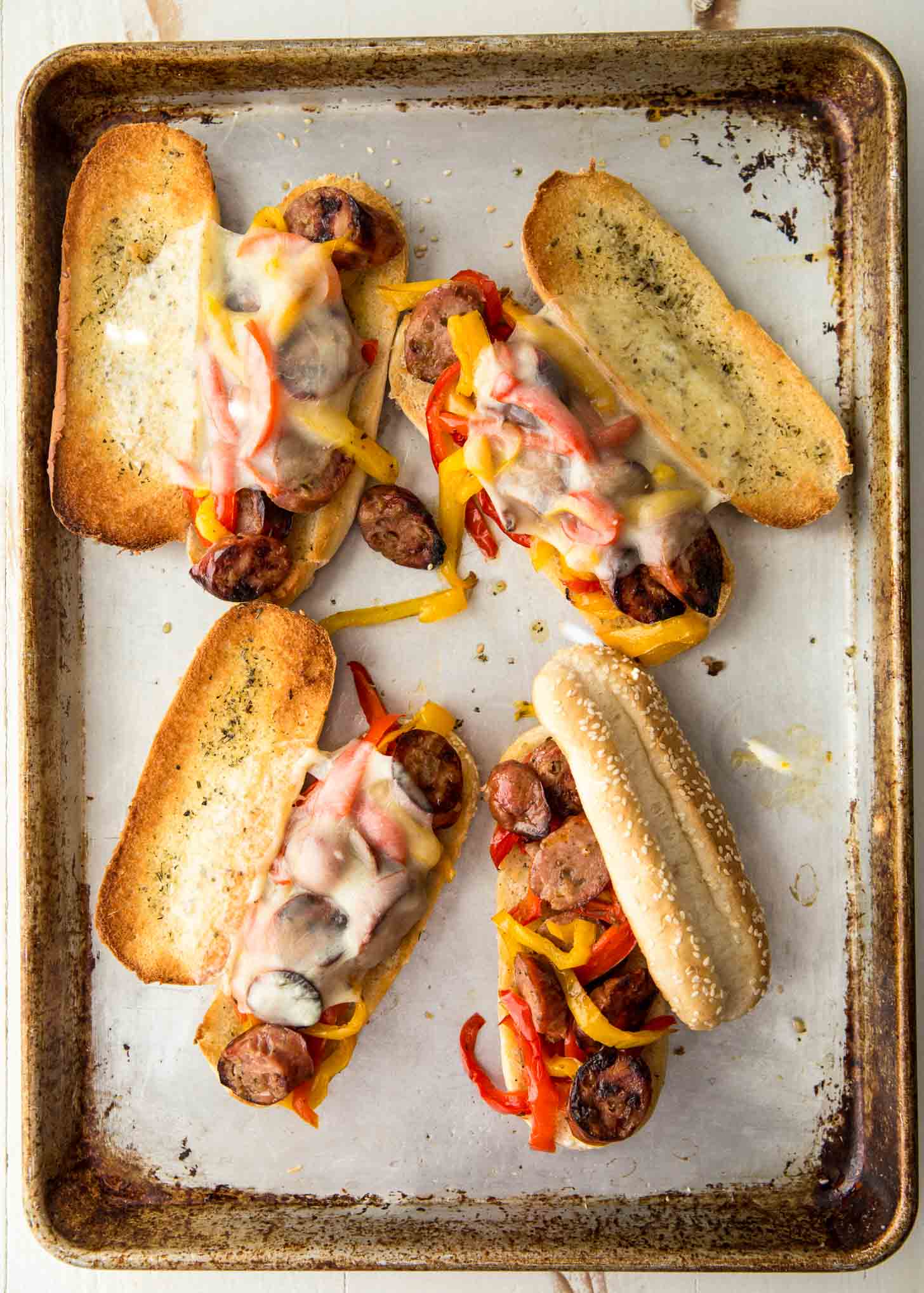 sausage and peppers on buns and topped with cheese