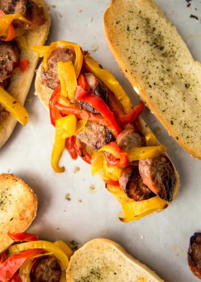 sheet pan sausage and peppers on a bun