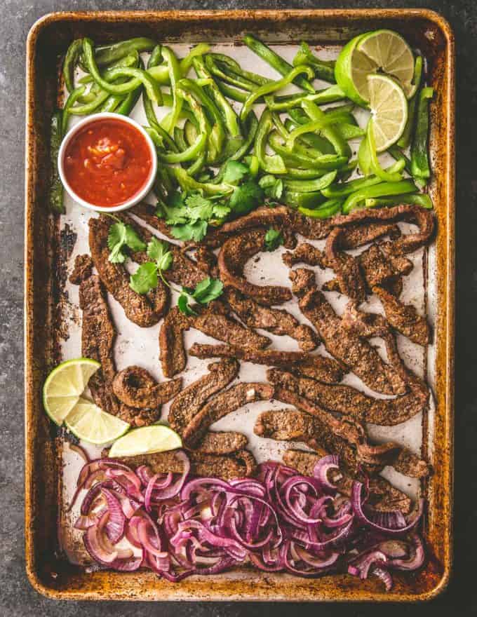  steak fajitas and peppers on a sheet pan