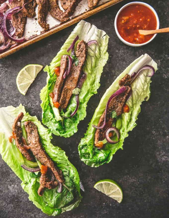 sheet pan steak fajitas on lettuce cups with salsa