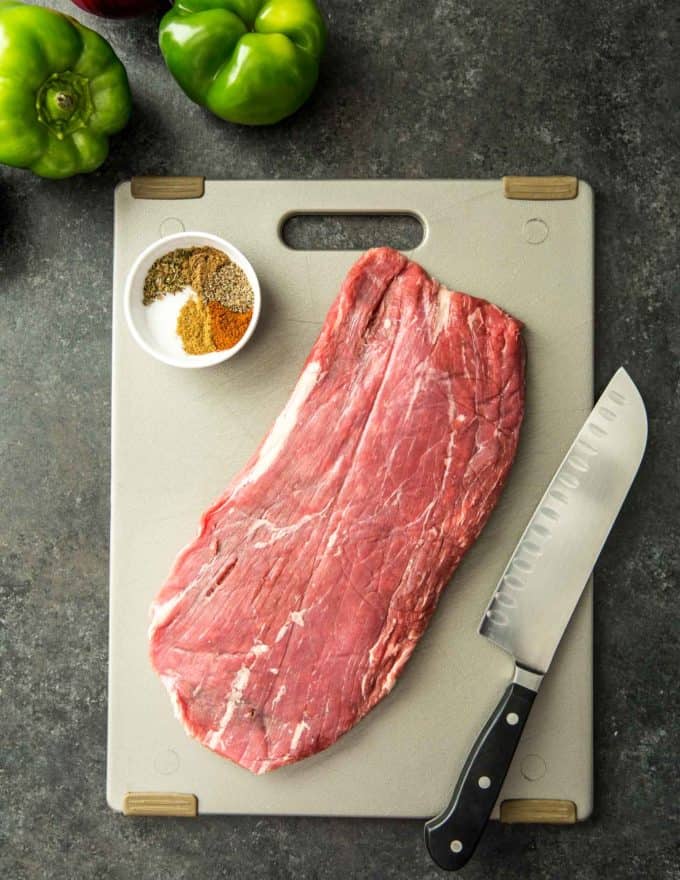 flank steak and taco seasoning on a cutting board