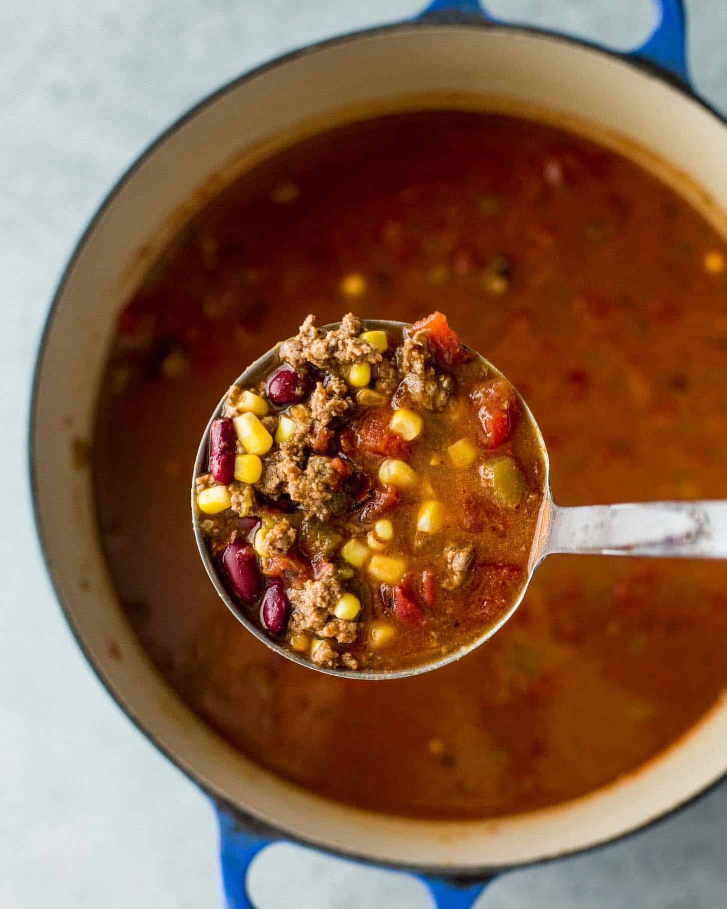 a spoonful of taco soup over a dutch oven