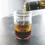 glass jar with vinegar and olive oil for a basic vinaigrette