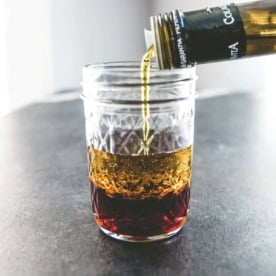 glass jar with vinegar and olive oil for a basic vinaigrette