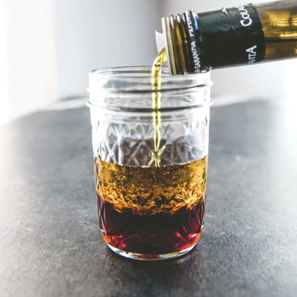 glass jar with vinegar and olive oil for a basic vinaigrette