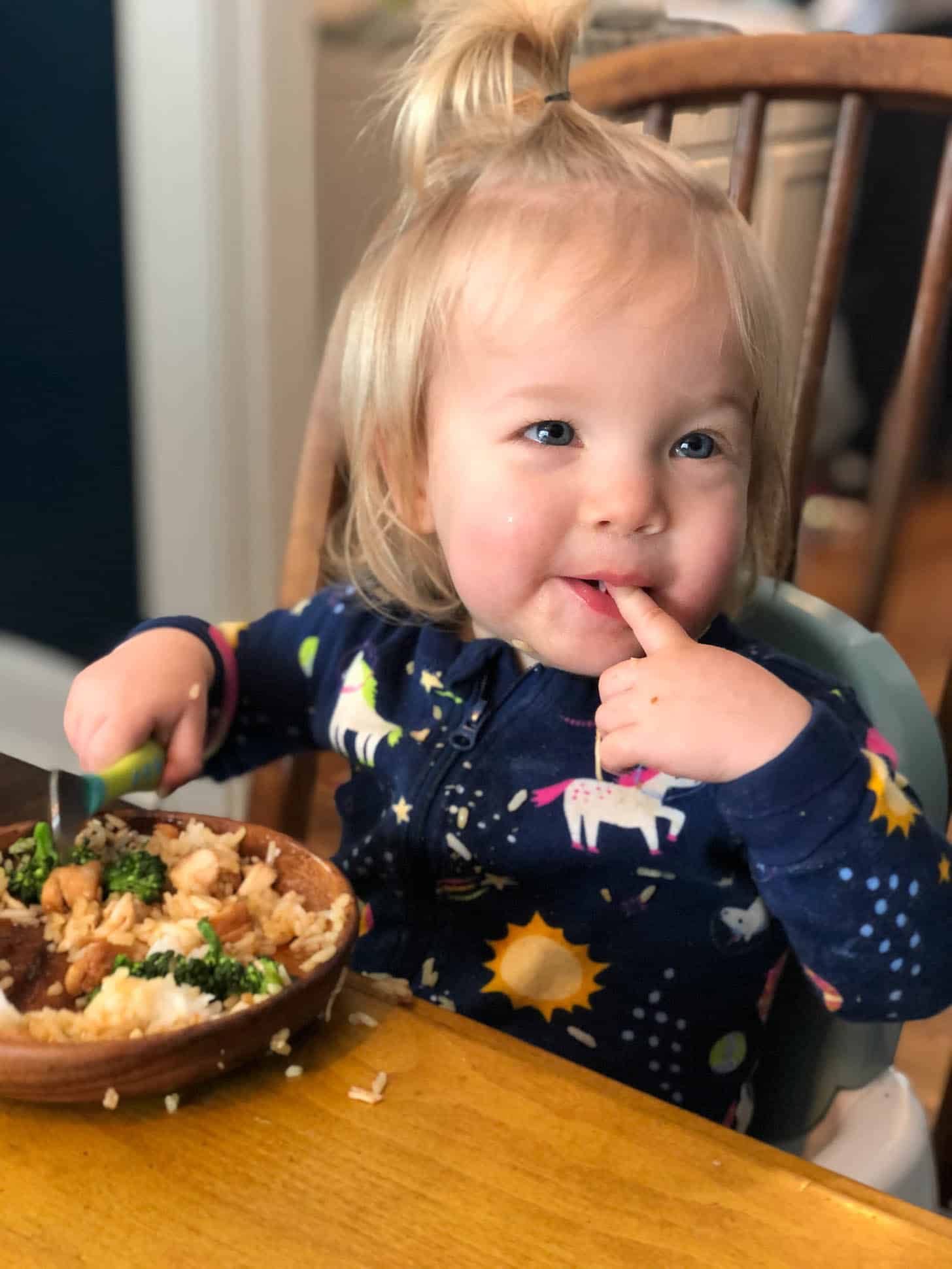 little girl eating teriyaki chicken