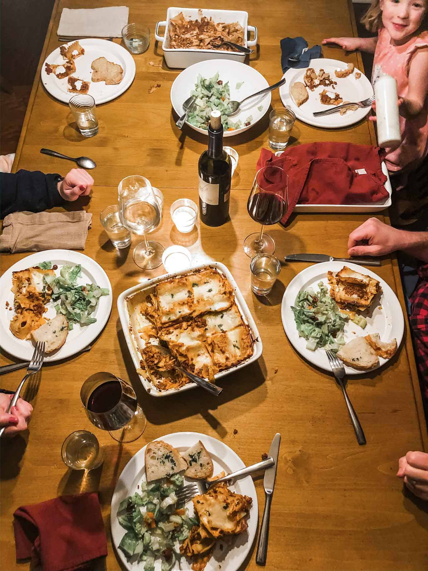 plates of lasagna bolognese and salad