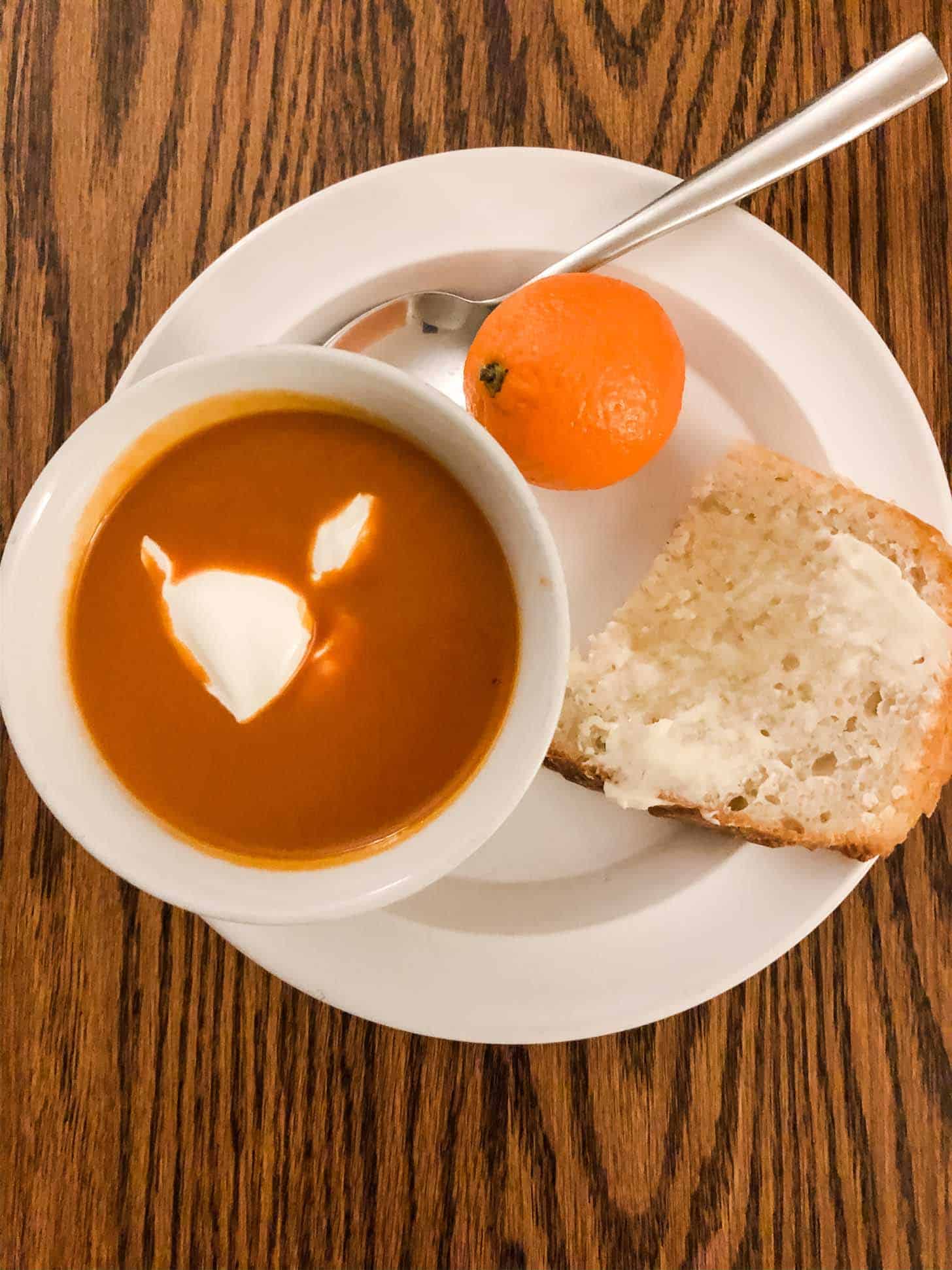 soup in a bowl with toast on a plate