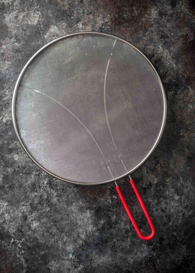 splatter screen on a grey countertop
