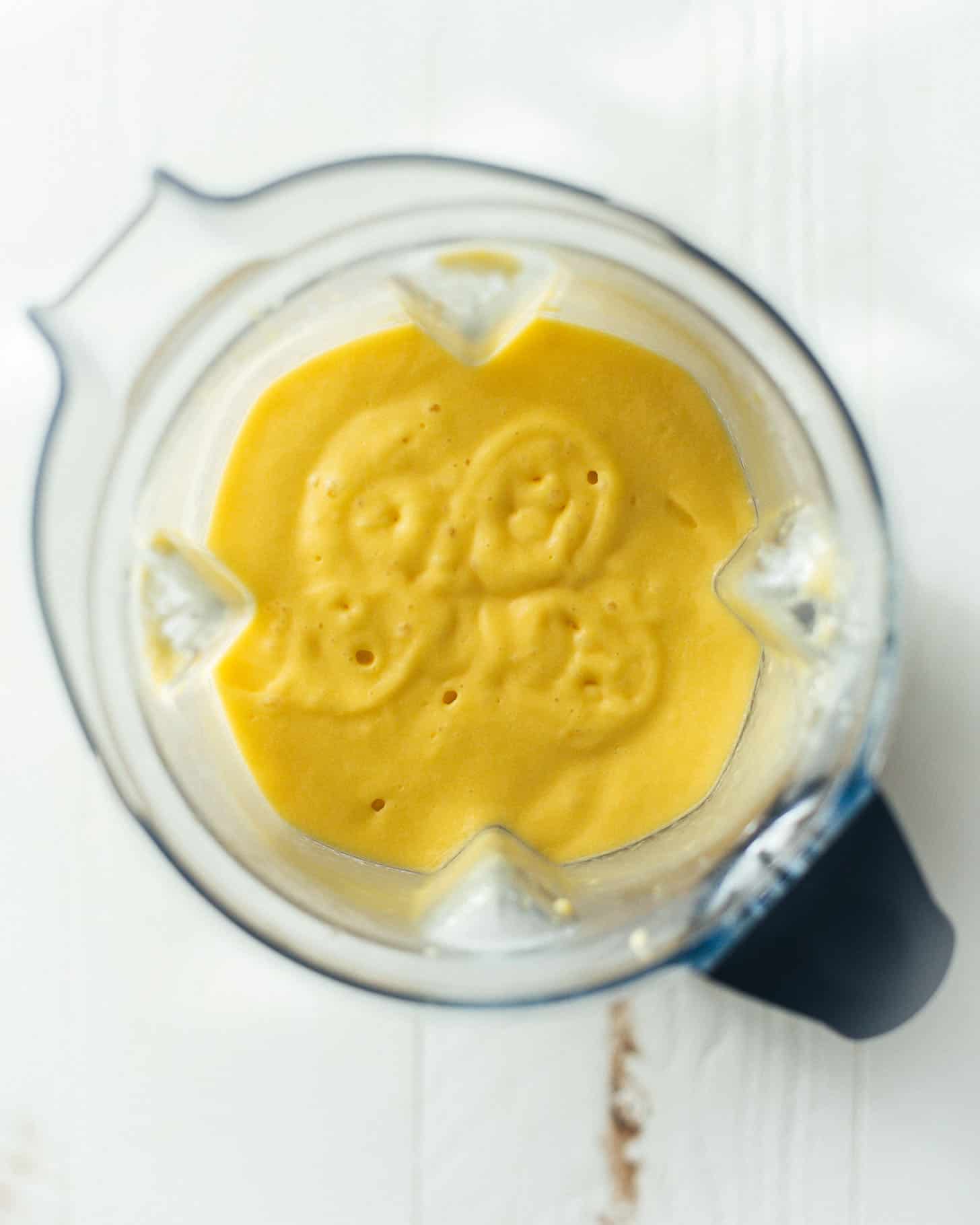 overhead image of mango puree in a blender