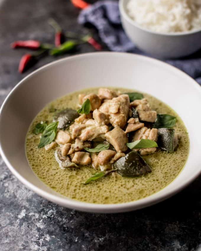 thai green curry with chicken in a white bowl