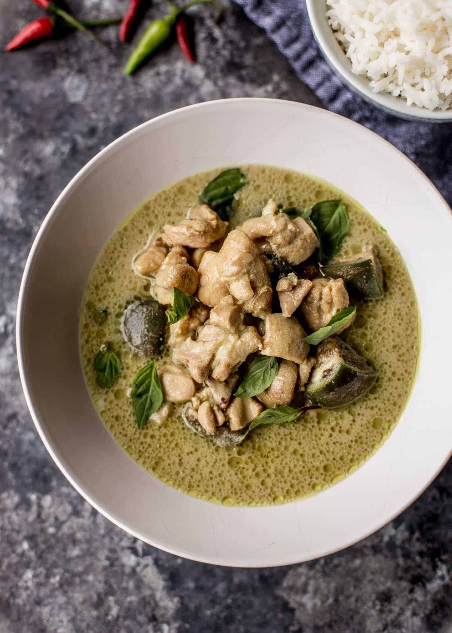 overhead image of thai green curry in a white bowl