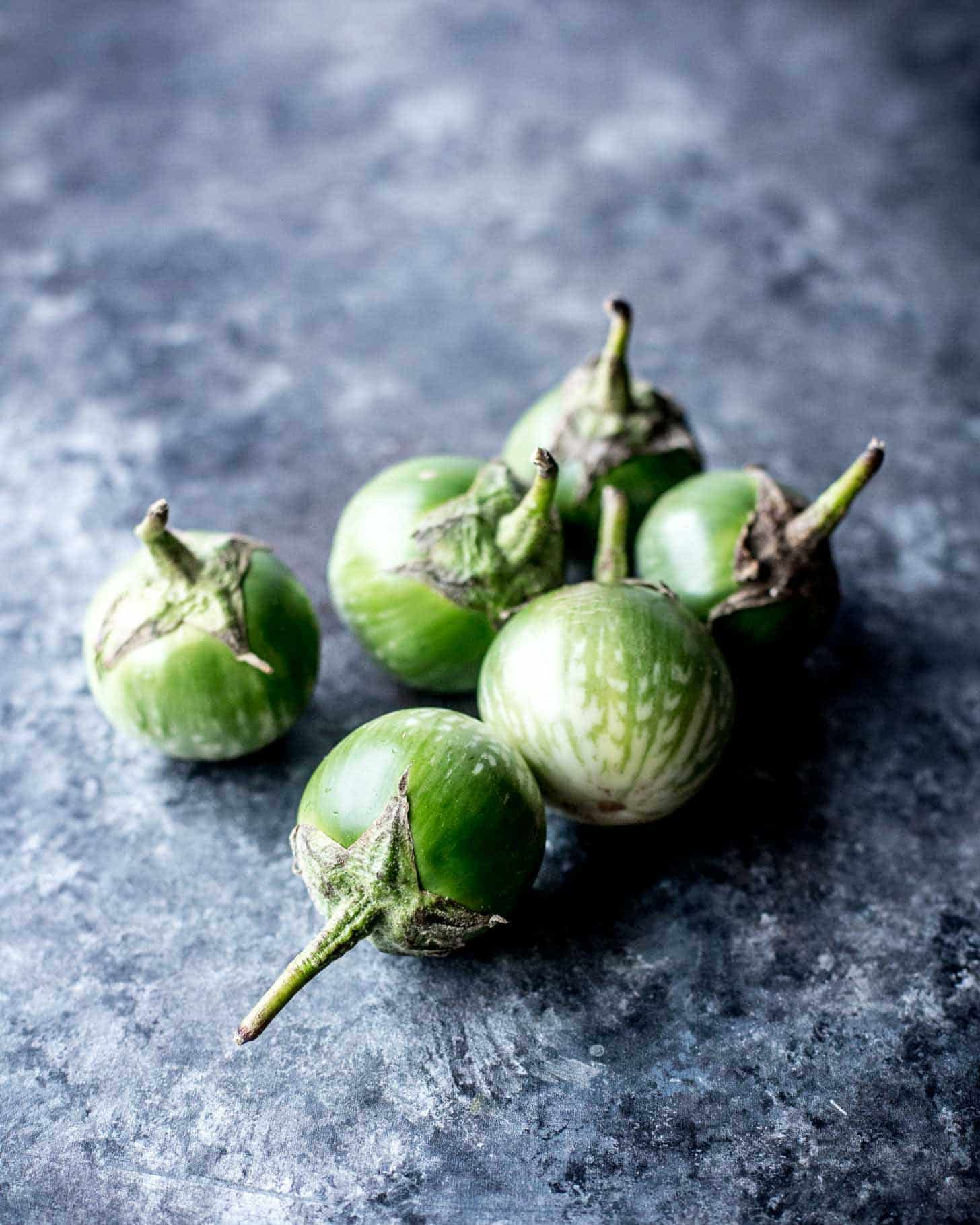 Thai green eggplants on a grey countertop