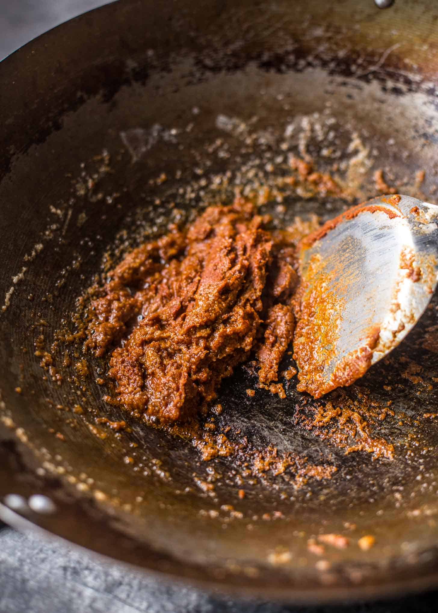 making massaman curry paste in a wok
