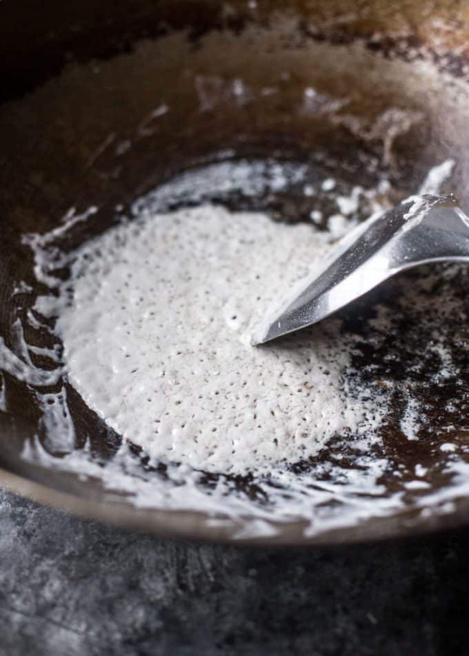 breaking coconut milk in a wok