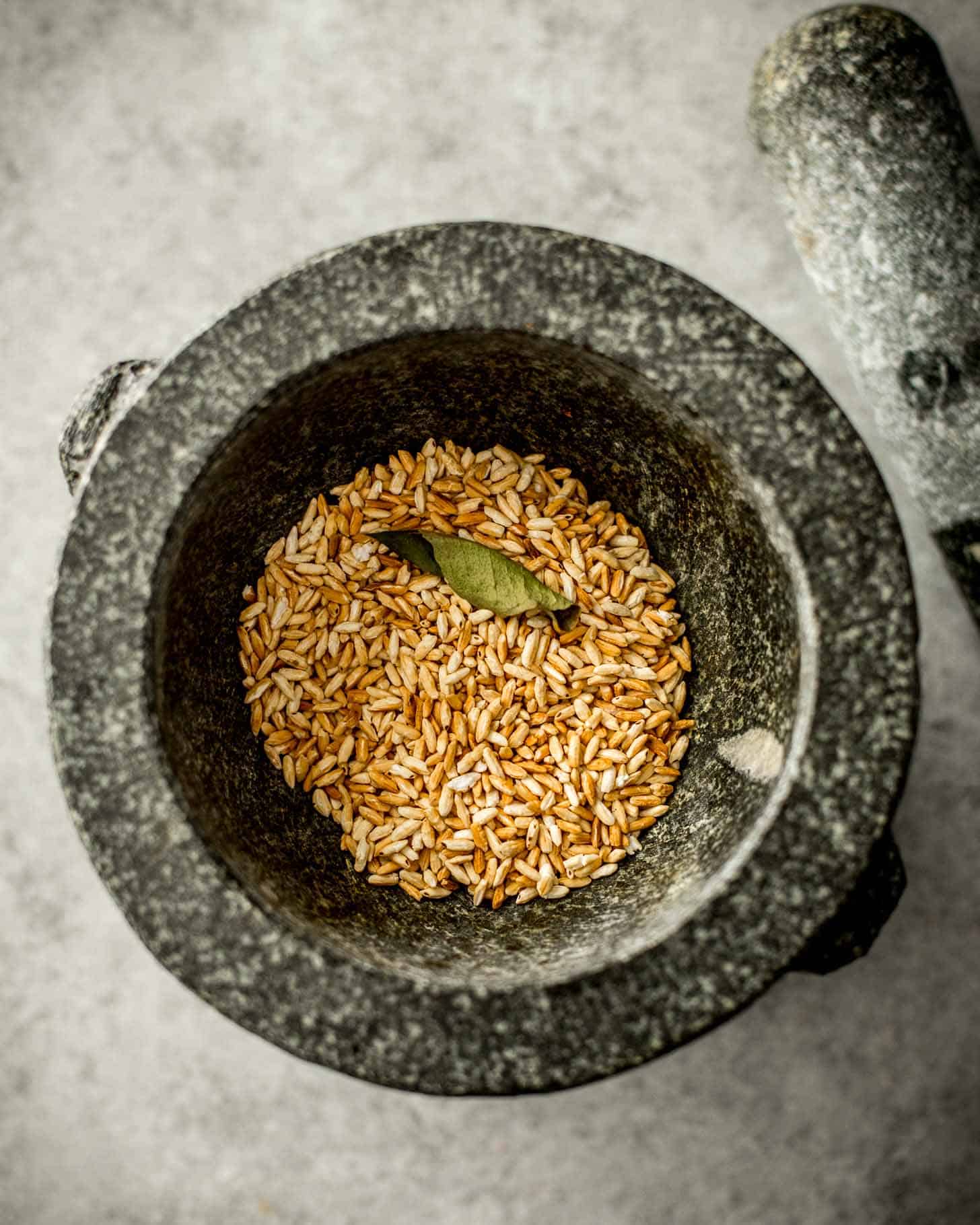 overhead image of toasted rice with a mortar and pestle