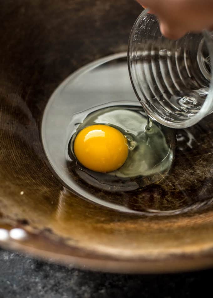 adding an egg to a wok