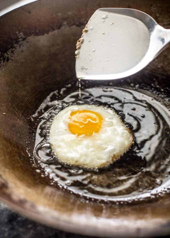 frying an egg in a wok