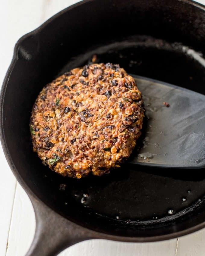 black bean and quinoa veggie burger in a cast iron skillet