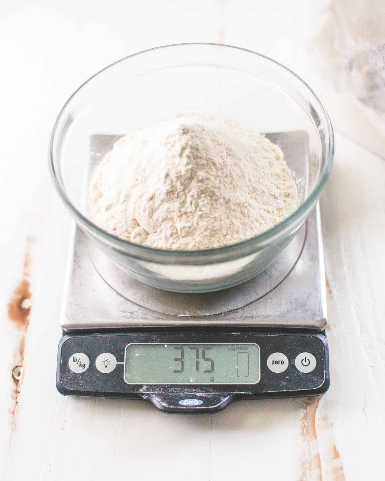 weighing flour for cookies on a kitchen scale