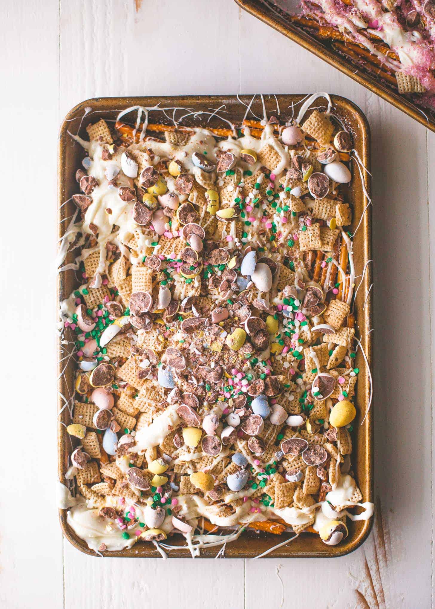 overhead image of Easter Egg Crunch Bark on a sheet pan on a white table