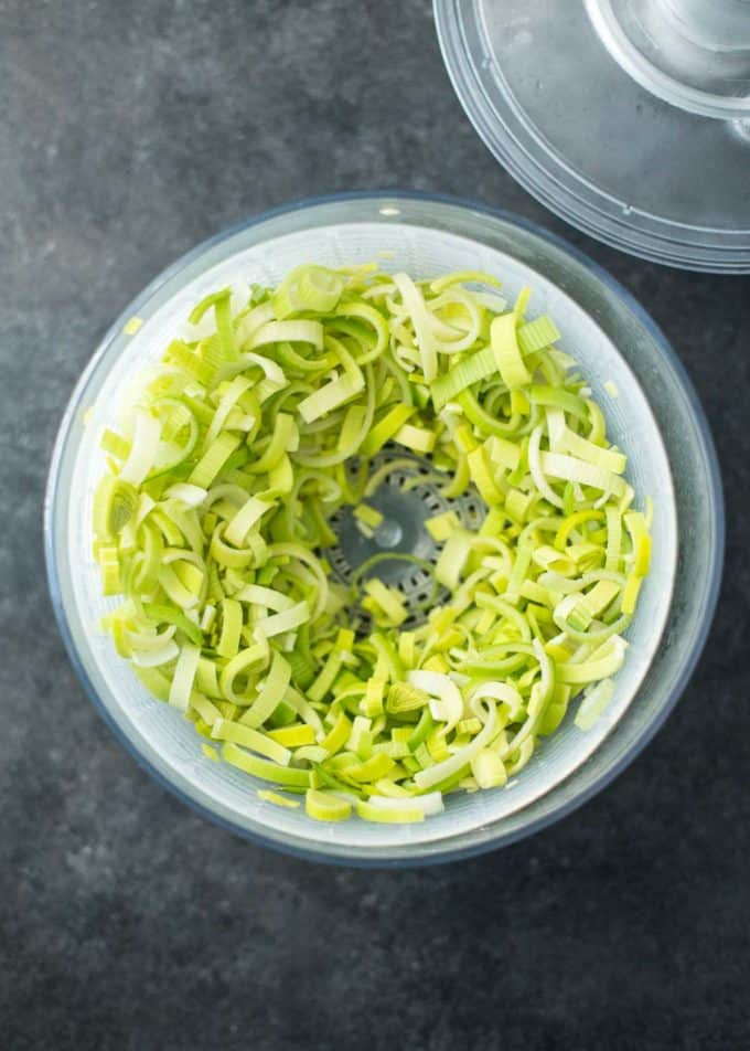 chopped leeks in a salad spinner