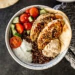 mediterranean chicken quinoa bowl on a grey tabletop