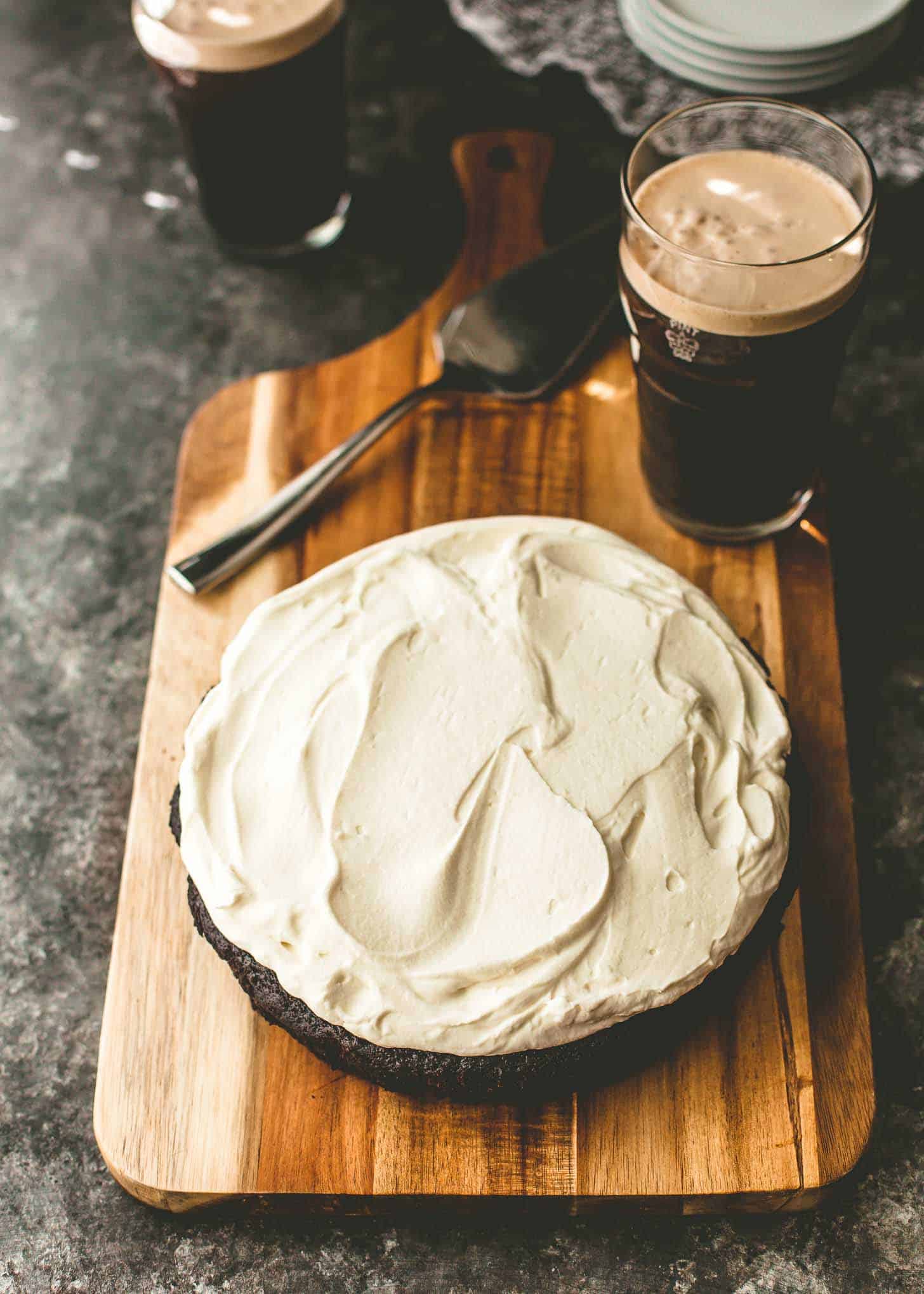 one bowl chocolate Guinness cake on a wood cutting board next to a glass of Guinness