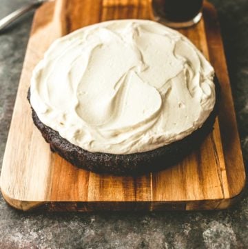 a round One-Bowl Chocolate Guinness Cake on a wooden tray