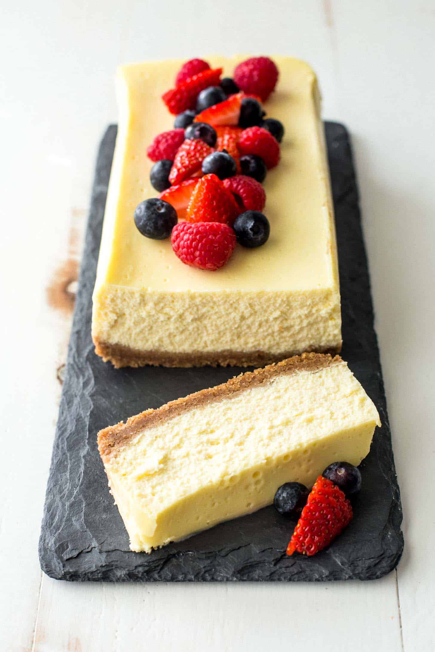 slow cooker classic cheesecake on a grey slate