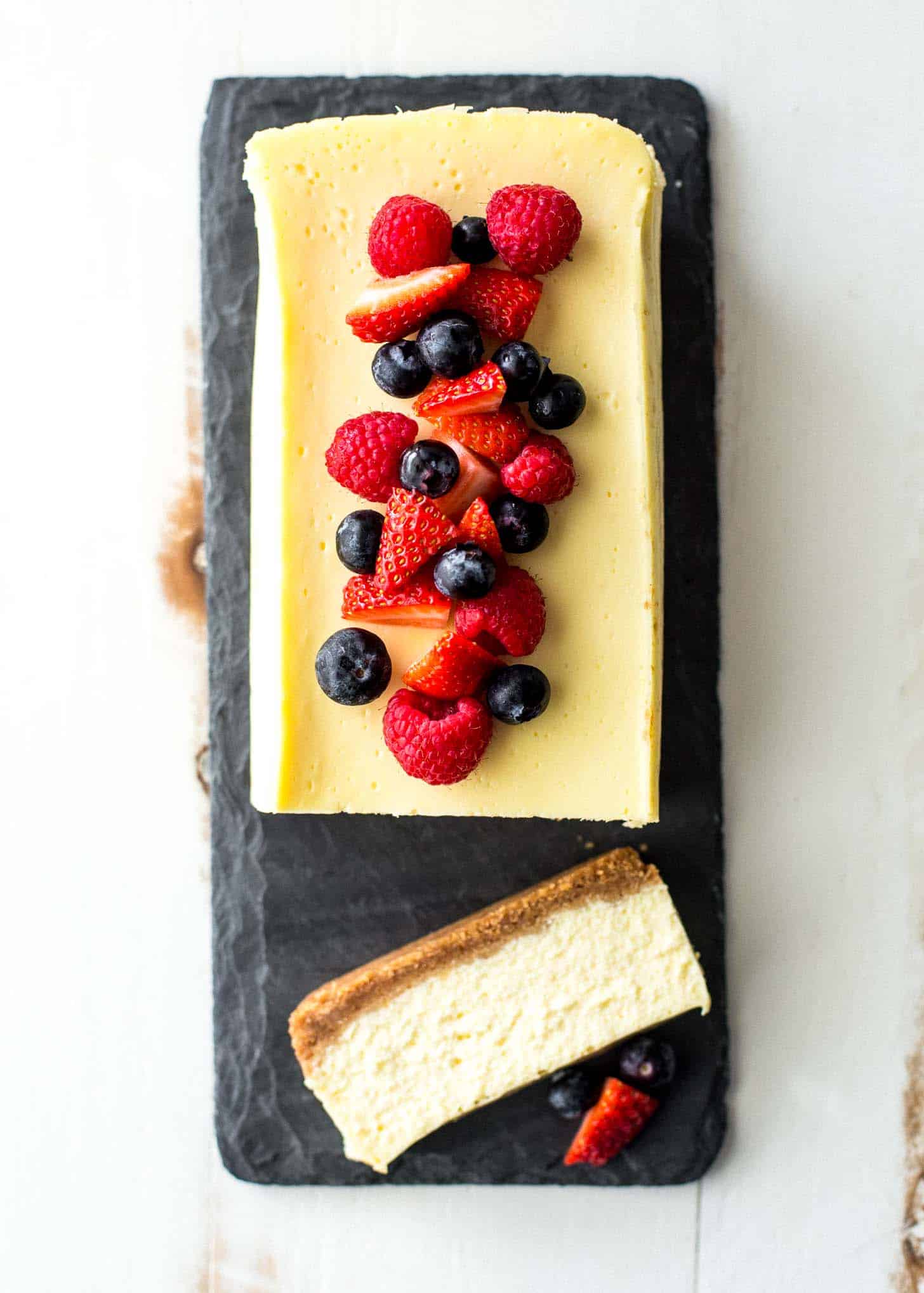 overhead image of slow cooker classic cheesecake on a slate board